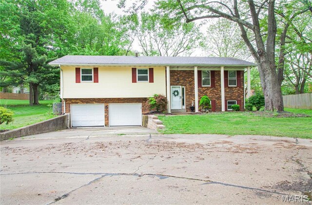 504 Leawood Dr, Swansea, IL 62226 - bi-level home featuring a garage, concrete driveway, and brick siding
