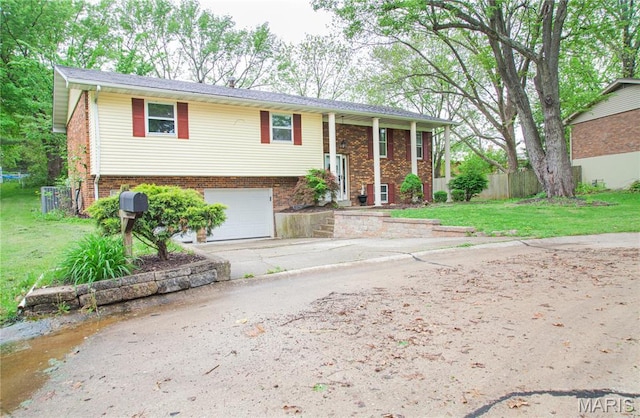 504 Leawood Dr, Swansea, IL 62226 - split foyer home with concrete driveway, a garage, and brick siding