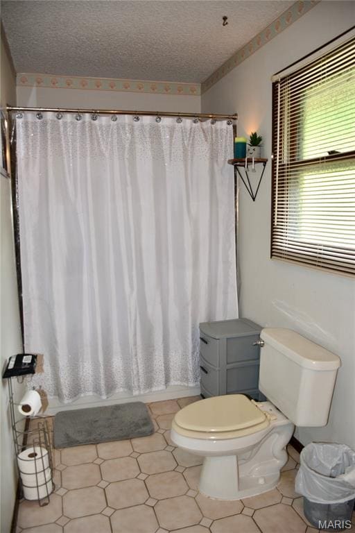 258 Hideaway Trl, Eureka, MO 63025 - bathroom with toilet, a textured ceiling, and shower / tub combo