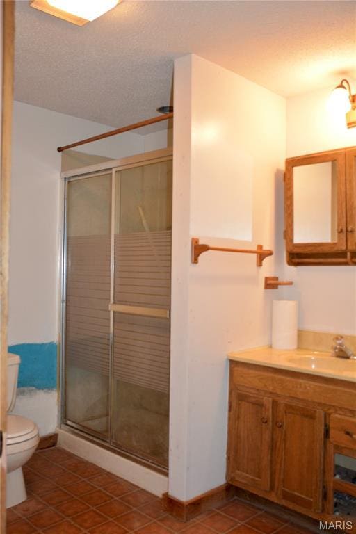 258 Hideaway Trl, Eureka, MO 63025 - full bathroom with toilet, a shower stall, vanity, tile patterned flooring, and a textured ceiling