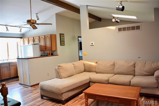 258 Hideaway Trl, Eureka, MO 63025 - living area with rail lighting, a ceiling fan, and wood finished floors