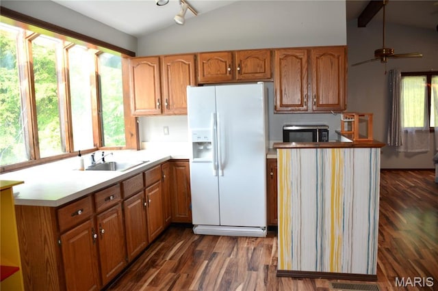258 Hideaway Trl, Eureka, MO 63025 - kitchen featuring white fridge with ice dispenser, a sink, stainless steel microwave, dark wood finished floors, and light countertops
