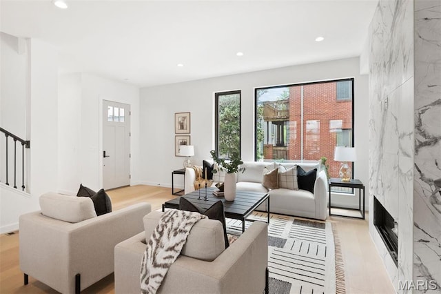 215 N Sarah St Unit 12, Saint Louis, MO 63108 - living room with recessed lighting, stairway, light wood-type flooring, and a premium fireplace