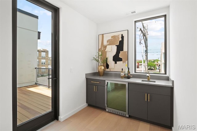 215 N Sarah St Unit 12, Saint Louis, MO 63108 - indoor wet bar with wine cooler, light wood-type flooring, and baseboards