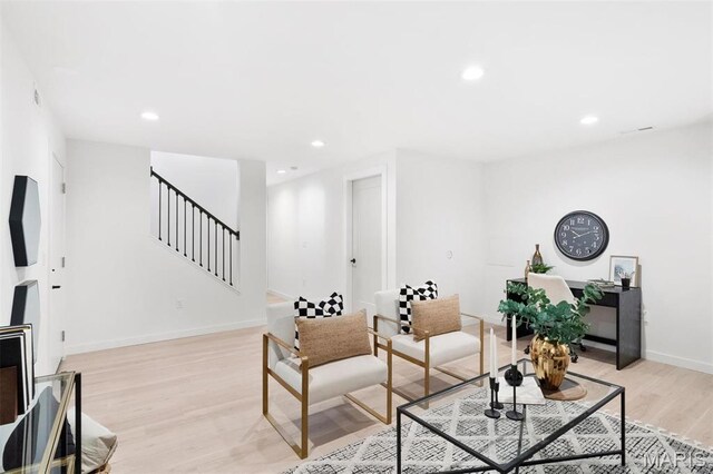 215 N Sarah St Unit 12, Saint Louis, MO 63108 - living room featuring light wood-style floors, stairs, baseboards, and recessed lighting