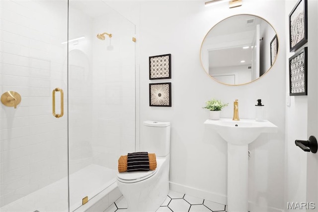 215 N Sarah St Unit 12, Saint Louis, MO 63108 - bathroom with toilet, a shower stall, baseboards, and tile patterned floors