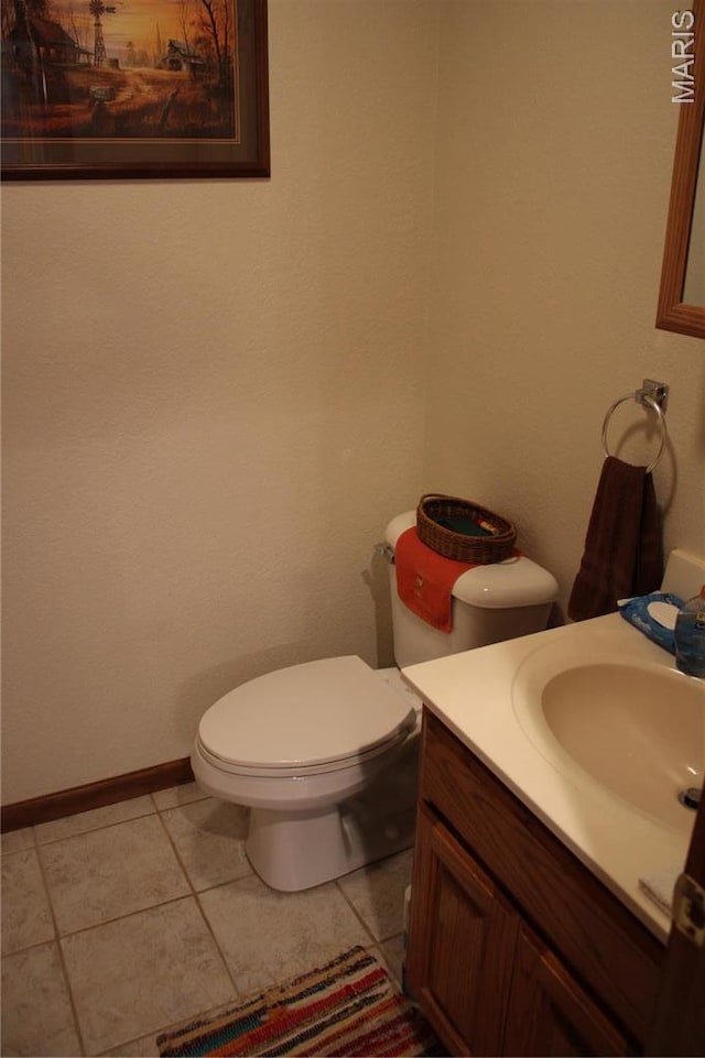 16255 Monroe Rd Unit 875, Paris, MO 65275 - half bathroom featuring vanity, tile patterned floors, toilet, and baseboards