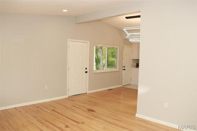 2530 N Waterford Dr, Florissant, MO 63033 - spare room with vaulted ceiling, light wood-style flooring, baseboards, and recessed lighting