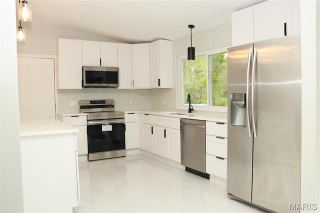 2530 N Waterford Dr, Florissant, MO 63033 - kitchen with appliances with stainless steel finishes, a sink, decorative backsplash, white cabinetry, and lofted ceiling
