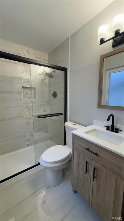 2530 N Waterford Dr, Florissant, MO 63033 - bathroom featuring a shower stall, vanity, and toilet