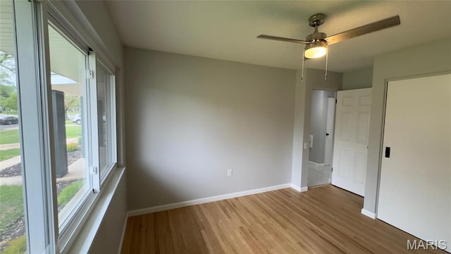 2530 N Waterford Dr, Florissant, MO 63033 - empty room with plenty of natural light, wood finished floors, baseboards, and ceiling fan