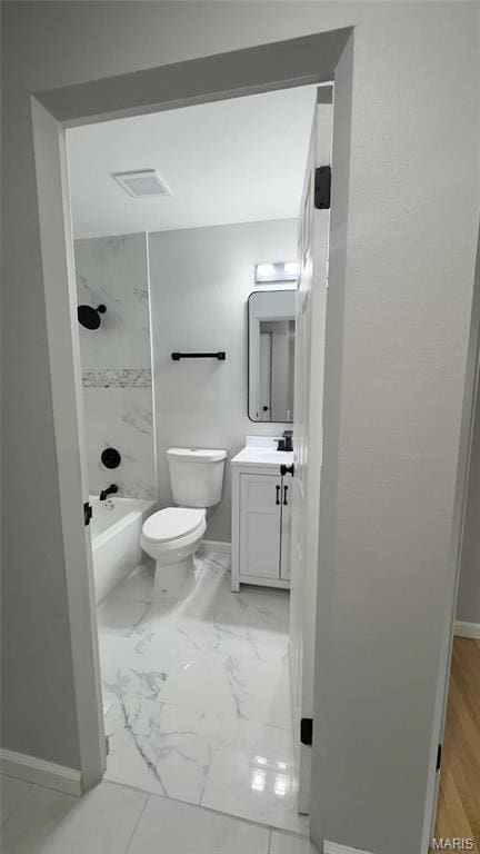 2530 N Waterford Dr, Florissant, MO 63033 - bathroom featuring baseboards, vanity, marble look tile flooring, toilet, and washtub / shower combination