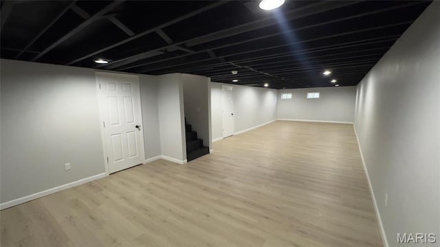 2530 N Waterford Dr, Florissant, MO 63033 - finished basement with stairs, wood finished floors, and baseboards