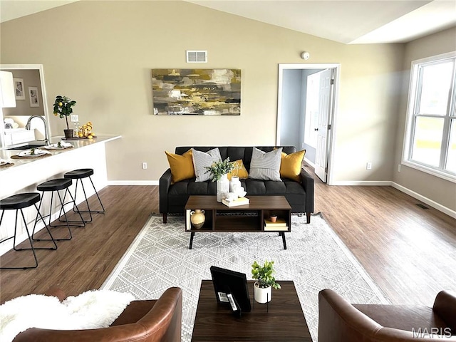 201 S Ashbrook, Bethalto, IL 62010 - living area with lofted ceiling, wood finished floors, and baseboards