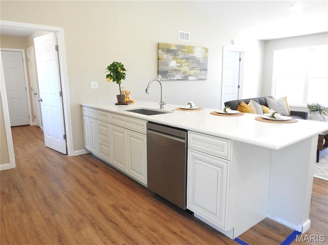 201 S Ashbrook, Bethalto, IL 62010 - kitchen featuring dishwasher, a sink, wood finished floors, light countertops, and white cabinetry