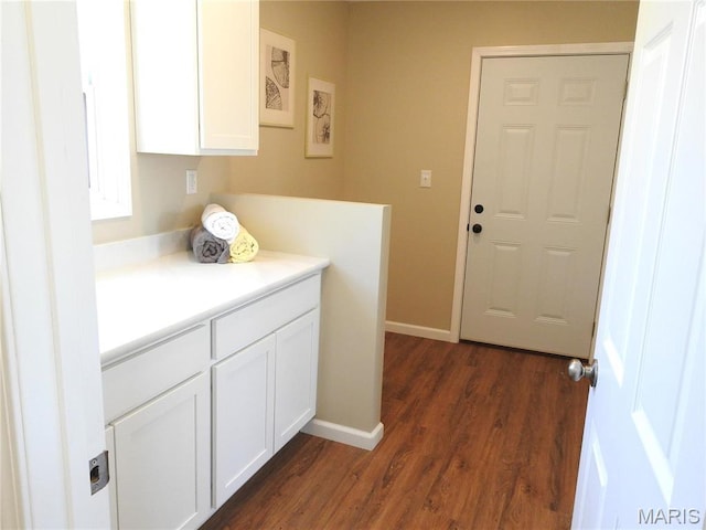 201 S Ashbrook, Bethalto, IL 62010 - laundry room with dark wood finished floors and baseboards