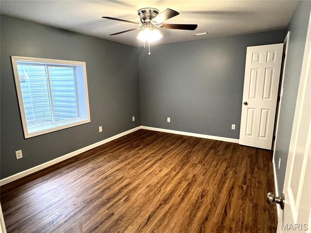 201 S Ashbrook, Bethalto, IL 62010 - empty room with ceiling fan, dark wood-style flooring, and baseboards