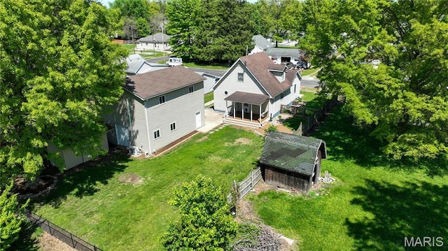 view of subject property featuring a tree filled landscape