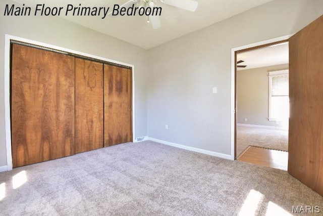 unfurnished bedroom featuring carpet, a closet, ceiling fan, and baseboards