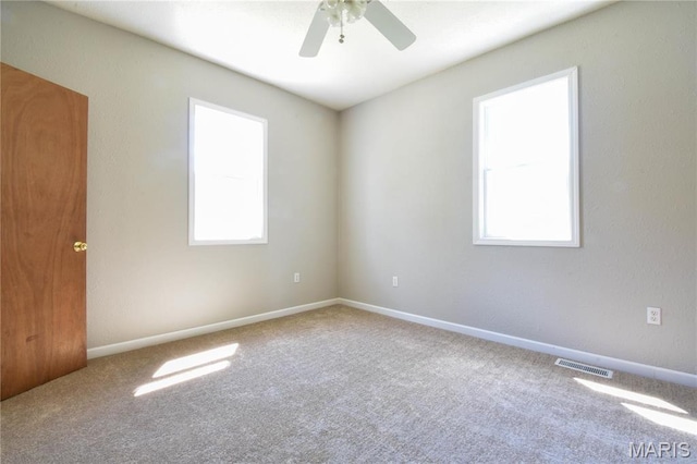 spare room with carpet, ceiling fan, and baseboards