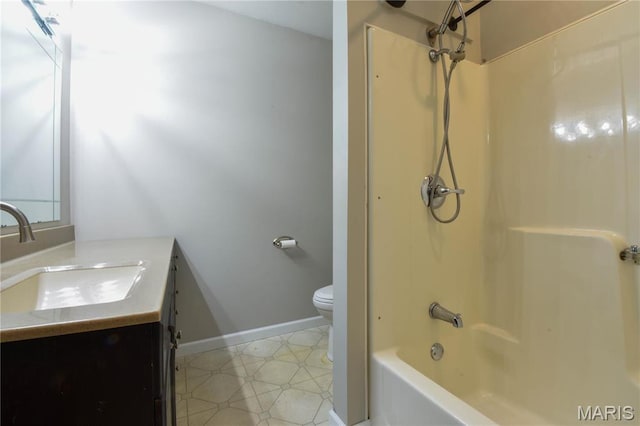full bathroom with toilet, vanity, baseboards, and washtub / shower combination