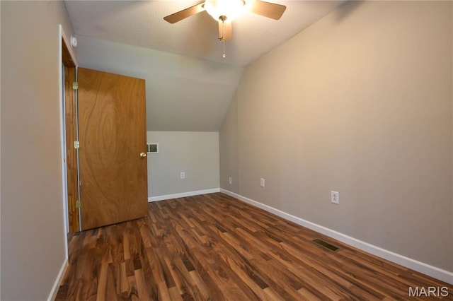bonus room featuring wood finished floors, vaulted ceiling, a ceiling fan, and baseboards