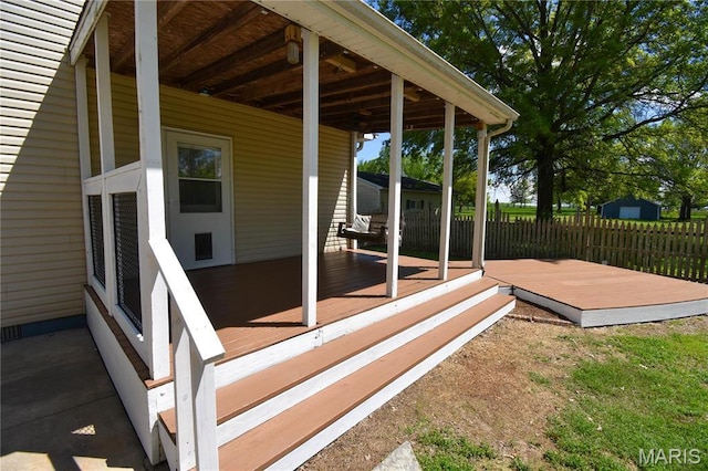 view of patio / terrace featuring fence and a wooden deck