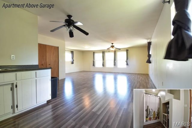 unfurnished living room with a ceiling fan and dark wood-type flooring