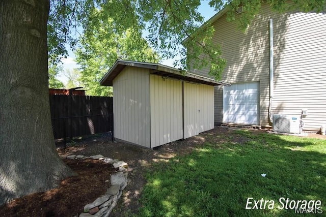 view of shed with ac unit and an attached garage