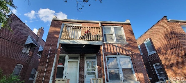5144 Palm St, Saint Louis, MO 63115 - townhome / multi-family property featuring a balcony and brick siding