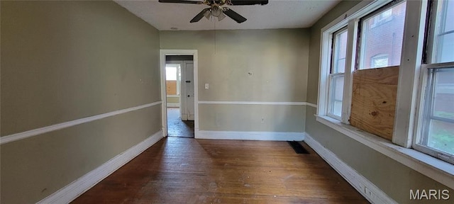 5144 Palm St, Saint Louis, MO 63115 - empty room featuring healthy amount of natural light, ceiling fan, wood finished floors, and baseboards