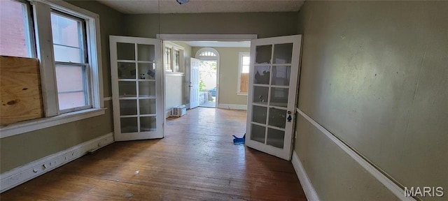 5144 Palm St, Saint Louis, MO 63115 - corridor featuring french doors, hardwood / wood-style flooring, and baseboards