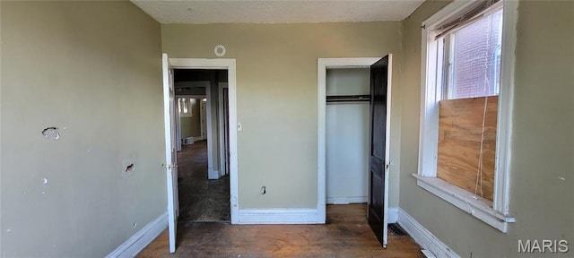 5144 Palm St, Saint Louis, MO 63115 - unfurnished bedroom featuring baseboards and a closet