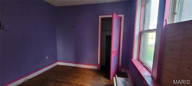 5144 Palm St, Saint Louis, MO 63115 - spare room with plenty of natural light, wood finished floors, and baseboards