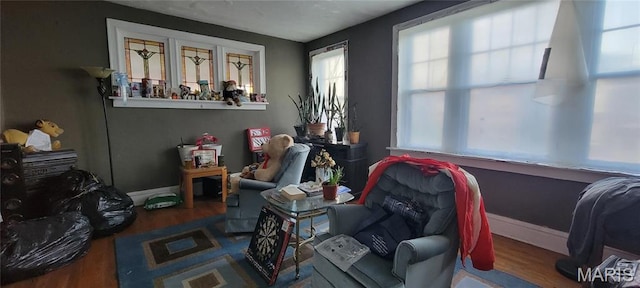 5144 Palm St, Saint Louis, MO 63115 - living area featuring wood finished floors and baseboards