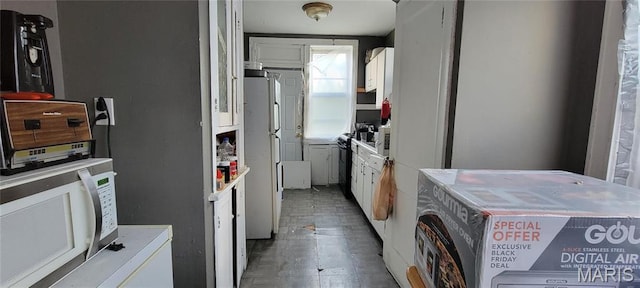 5144 Palm St, Saint Louis, MO 63115 - kitchen featuring white appliances, white cabinetry, and light countertops