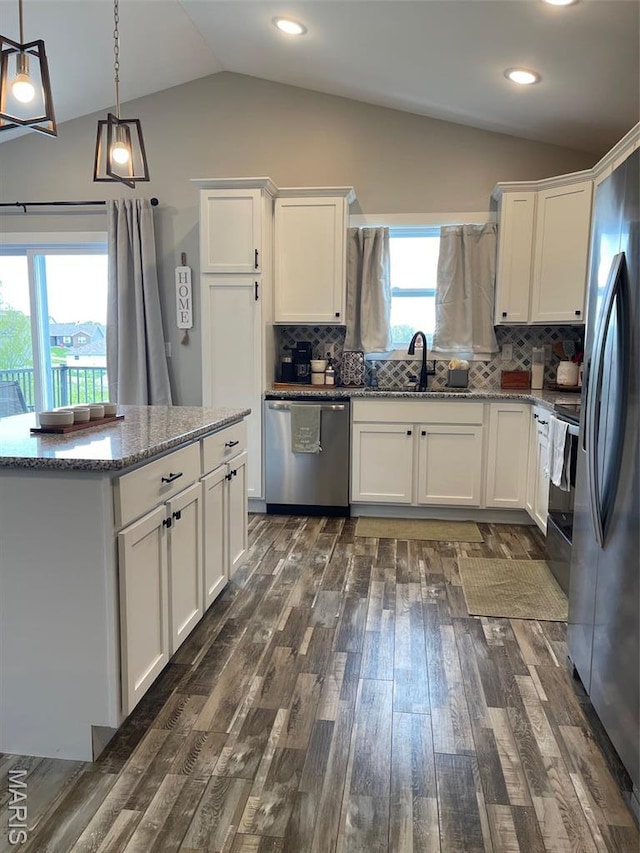 210 Boardwalk Ct, Union, MO 63084 - kitchen featuring appliances with stainless steel finishes, lofted ceiling, a sink, dark wood-type flooring, and white cabinetry