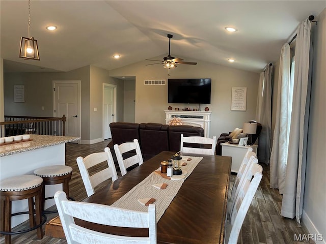 210 Boardwalk Ct, Union, MO 63084 - dining area with a ceiling fan, dark wood finished floors, baseboards, lofted ceiling, and a fireplace