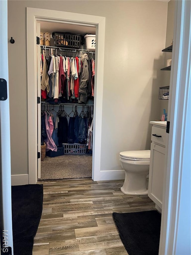 210 Boardwalk Ct, Union, MO 63084 - bathroom featuring vanity, wood finished floors, toilet, baseboards, and a spacious closet