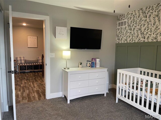 210 Boardwalk Ct, Union, MO 63084 - bedroom featuring dark carpet, a nursery area, baseboards, and wallpapered walls