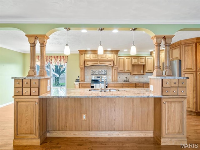10804 Campbell Rd, Coulterville, IL 62237 - kitchen with a sink, a center island with sink, light wood finished floors, light stone counters, and crown molding