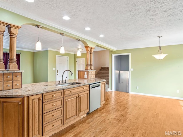 10804 Campbell Rd, Coulterville, IL 62237 - kitchen featuring dishwasher, ornate columns, a sink, light wood-type flooring, and a textured ceiling