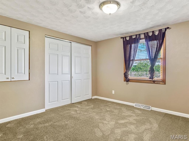 10804 Campbell Rd, Coulterville, IL 62237 - unfurnished bedroom with carpet floors, baseboards, and a textured ceiling