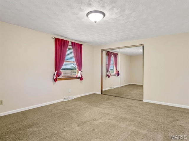 10804 Campbell Rd, Coulterville, IL 62237 - unfurnished bedroom with carpet, a closet, a textured ceiling, and baseboards