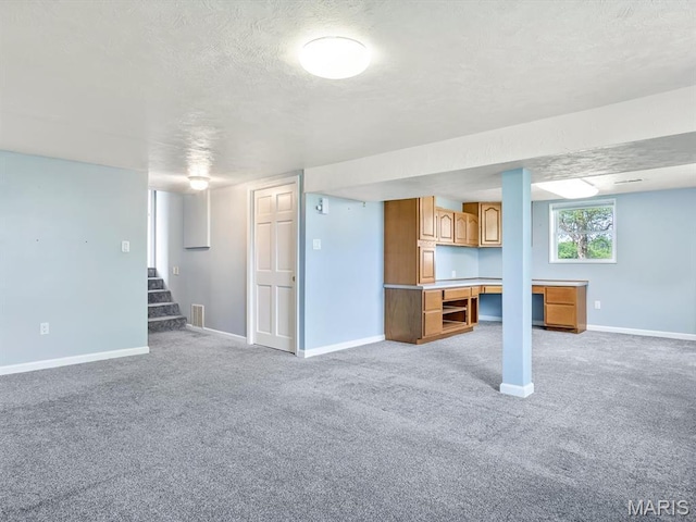 10804 Campbell Rd, Coulterville, IL 62237 - basement featuring light colored carpet, a textured ceiling, baseboards, and stairway
