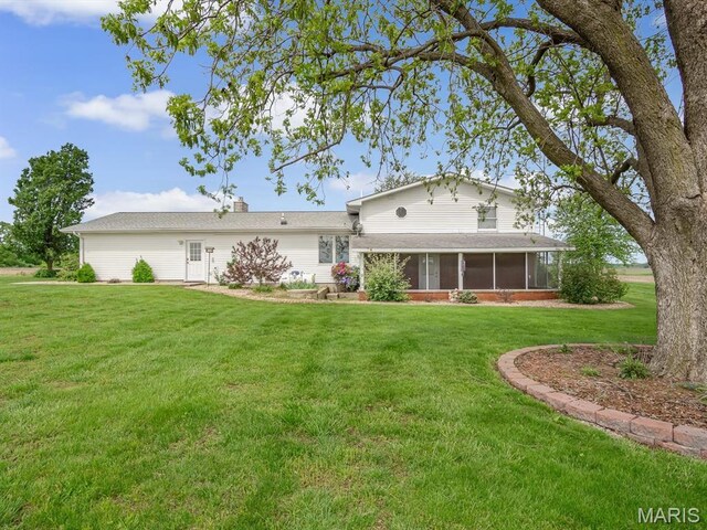 10804 Campbell Rd, Coulterville, IL 62237 - back of house with a sunroom and a lawn