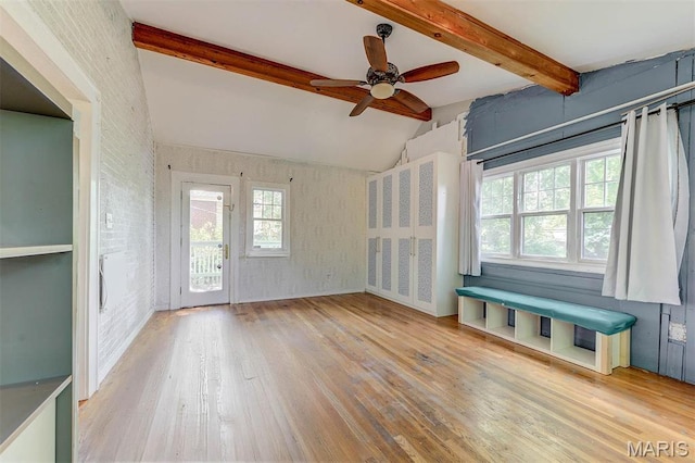 unfurnished living room featuring hardwood / wood-style flooring and a ceiling fan