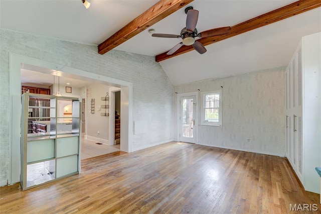 unfurnished living room featuring wood-type flooring and a ceiling fan