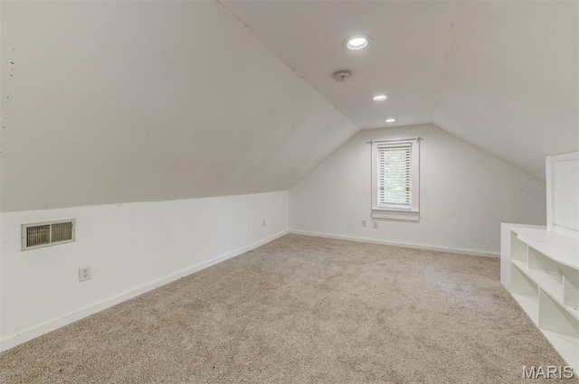 additional living space with lofted ceiling, light colored carpet, baseboards, and recessed lighting