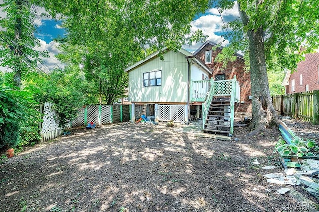 1723 Mccready Ave, Saint Louis, MO 63117 - back of house featuring a fenced backyard, stairway, and a wooden deck